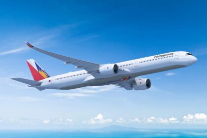 Philippine Airlines Airbus A350-1000 in flight against a blue sky.