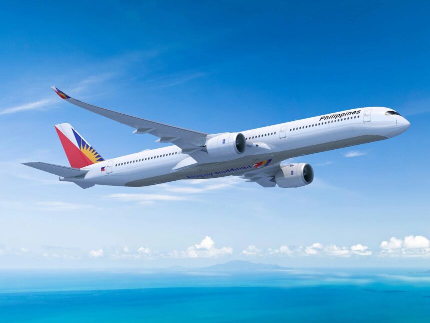 Philippine Airlines Airbus A350-1000 in flight against a blue sky.