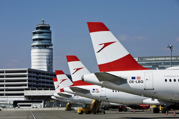 Austrian Airlines aircraft lined up at Vienna International Airport with just the tails in view