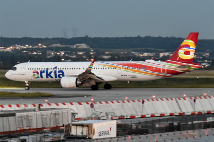 An Arkia Airbus A321 aircraft on the runway before takeoff. Blurry foreground and background.
