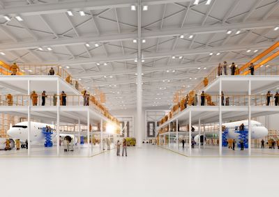 Image shows a well-lit warehouse style building with two aircraft being maintained on the ground floor and engineers next to them as well as on two floors above