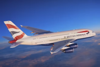 Right-hand side of a British Airways Airbus A380 aircraft flying with no clouds around it.