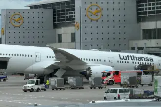 A Lufthansa Boeing 787-9 Dreamliner resting on its nose at Frankfurt Airport after a landing gear collapse with the aircraft positioned in front of a terminal building