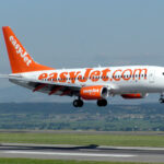 EasyJet Boeing 737-700 displaying its landing gear as it prepares to land at Bristol International Airport.