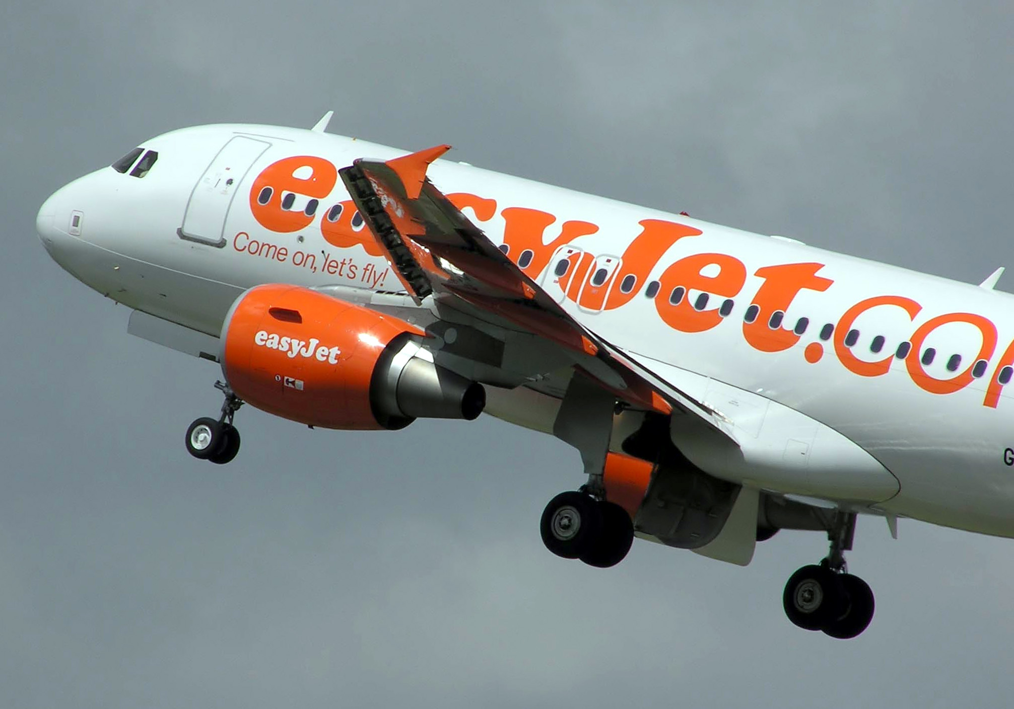 An easyJet Airbus A319 taking off into grey skies from Bristol International Airport.