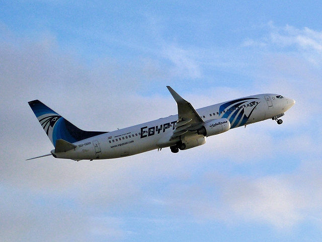 EgyptAir Boeing 737 ascending into a blue sky.