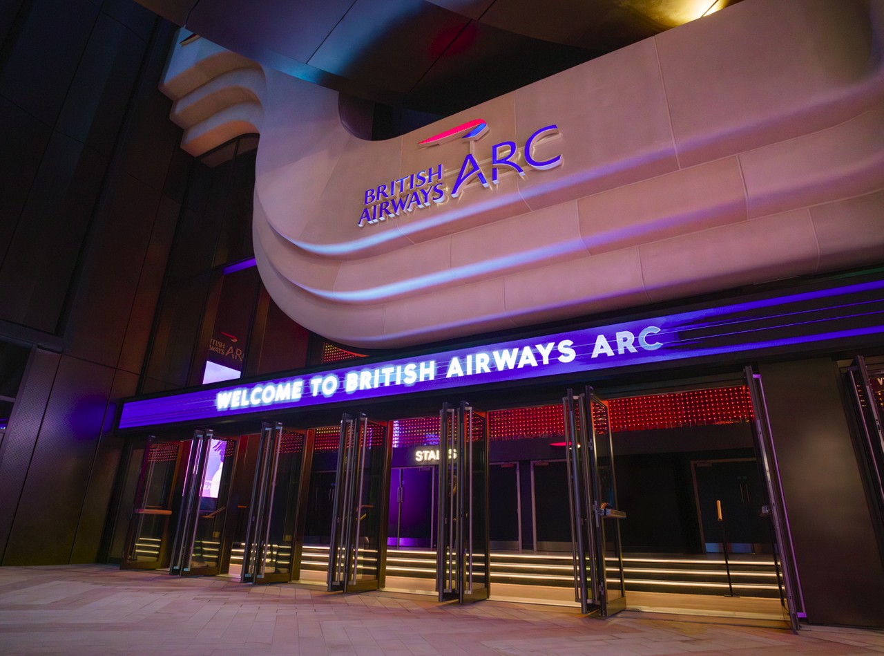 Six entrances to the British Airways ARC showing an illuminated 'Welcome to British Airways ARC' message.