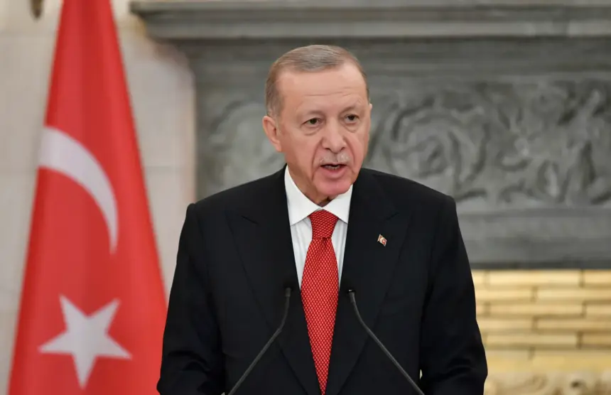 A close-up image of Turkish President Recep Tayyip Erdogan speaking at a conference in Athens, Greece