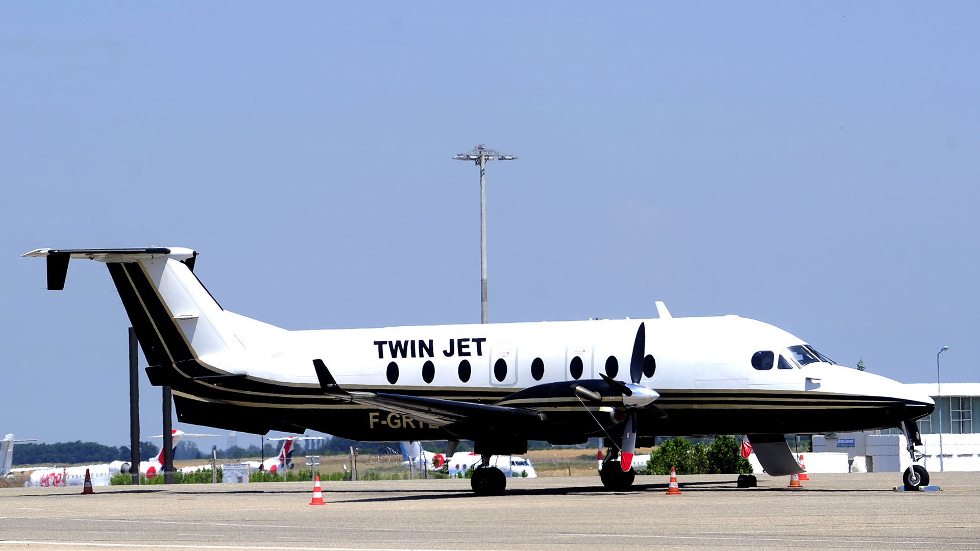 A Twin Jet plane at an airport.