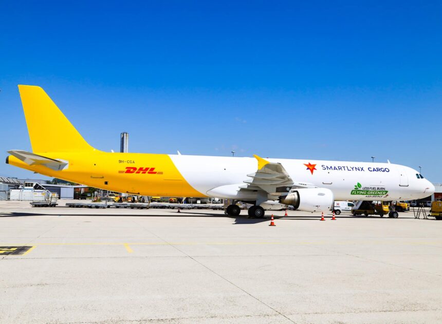 A DHL branded SmartLynx jet sat on a runway on a sunny day.
