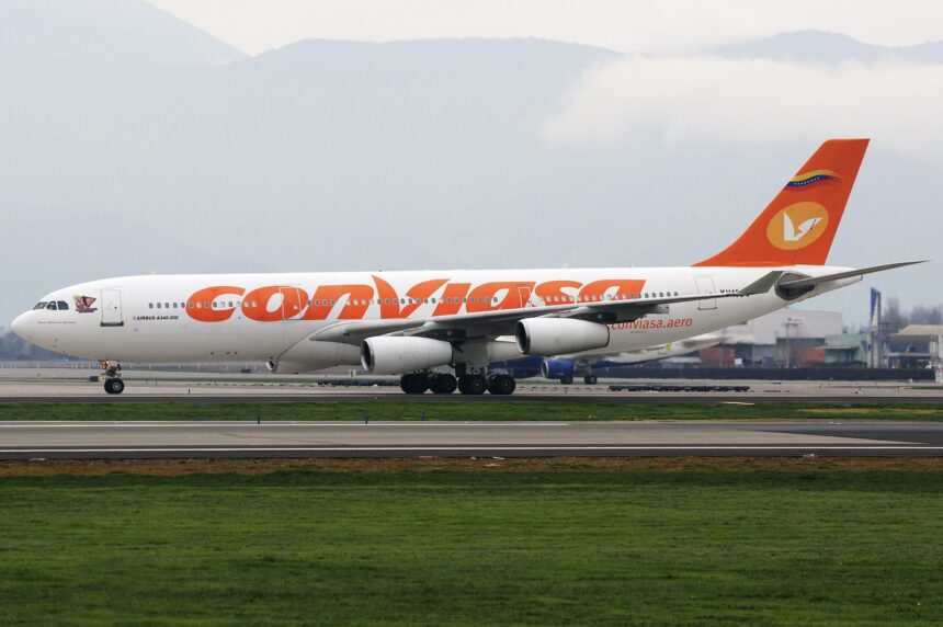 A Conviasa Airbus A340-200 jet on a runway in front of a green field.