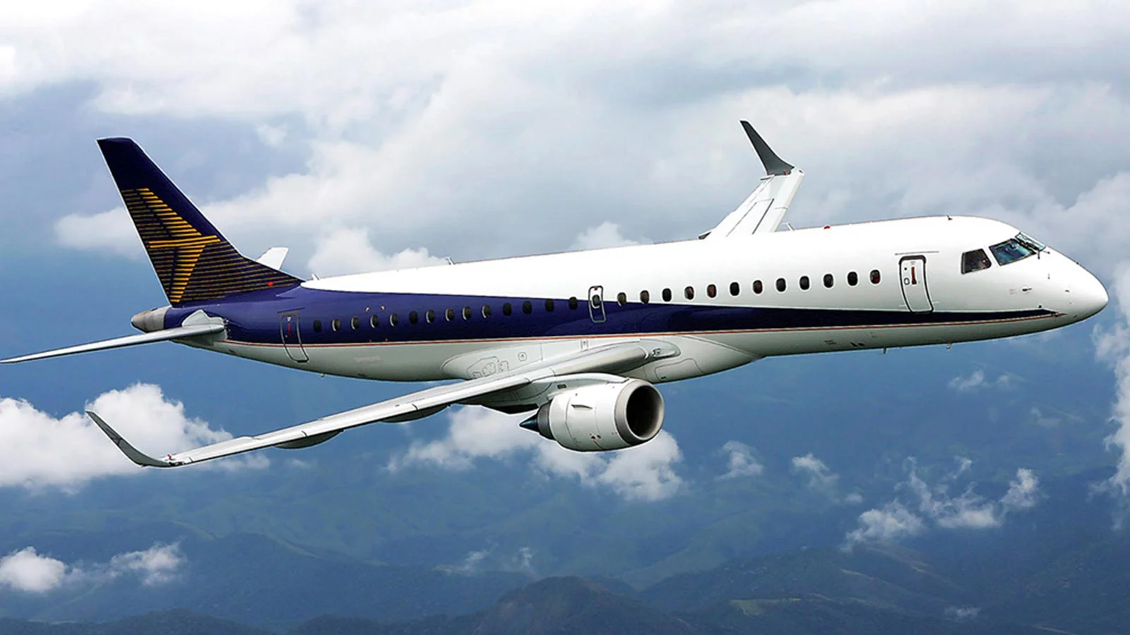 An Embraer E190 flying over a cloudy sky. The jet has a white body white body with a blue stripe, and a yellow logo on its tail.