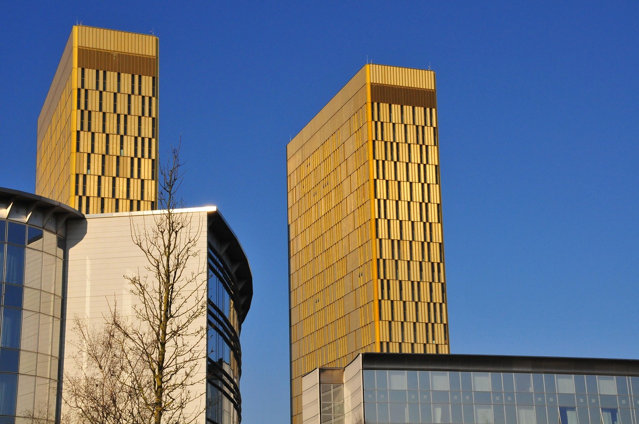 The outside of the European Court of Justice buildings in front of a clear blue sky.