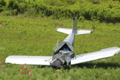A small aircraft crash in an open field. The cockpit crushed, no smoke.