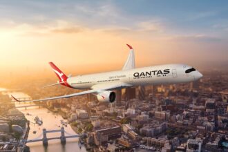 Qantas aircraft flying over London Thames and Tower Bridge amongst other main landmarks.