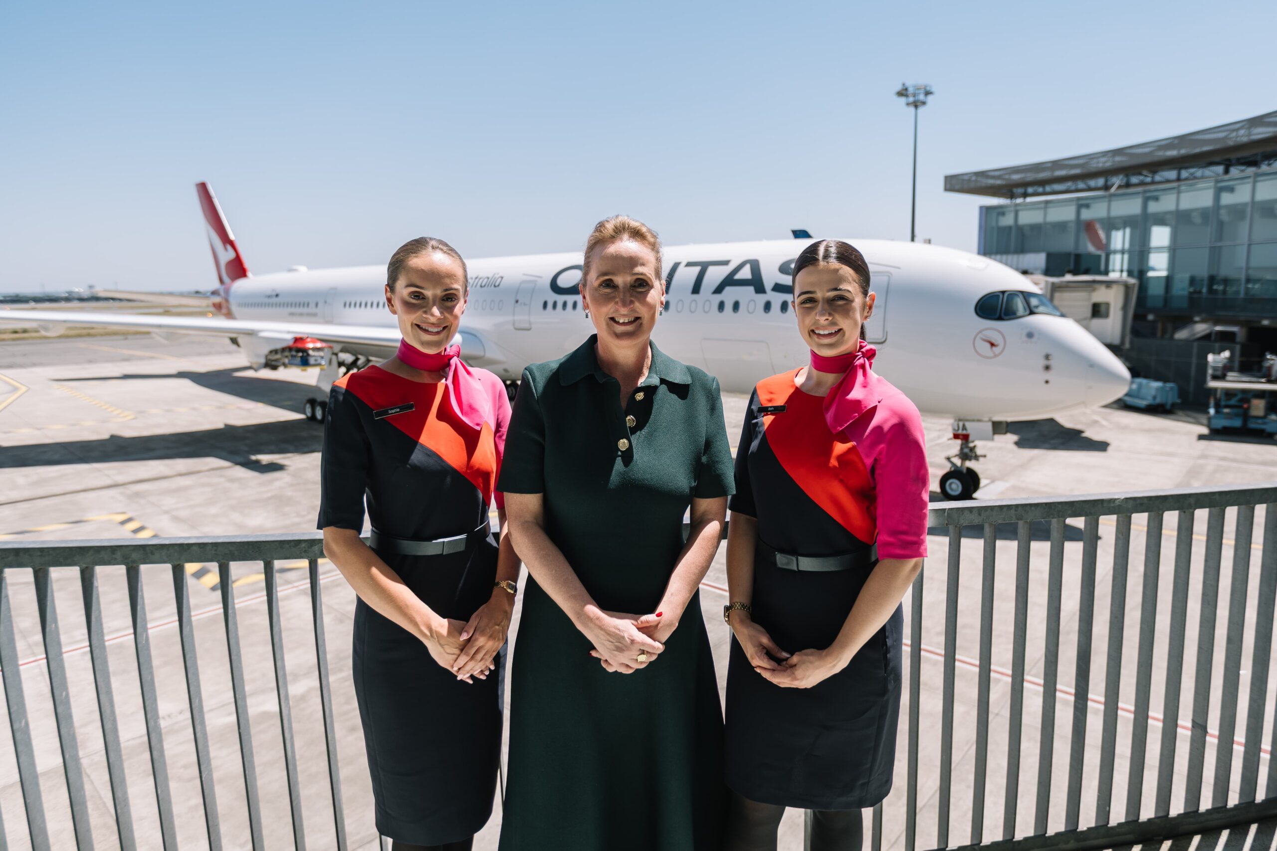 Three Qantas representatives stood in front of the A350 aircraft announced to be used for Project Sunrise.
