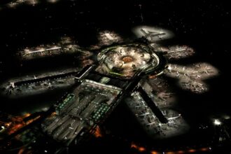 San Francisco International Airport seen from above at night. The runways and the terminals are lit.