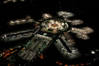 San Francisco International Airport seen from above at night. The runways and the terminals are lit.