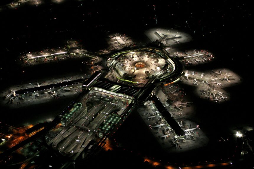 San Francisco International Airport seen from above at night. The runways and the terminals are lit.