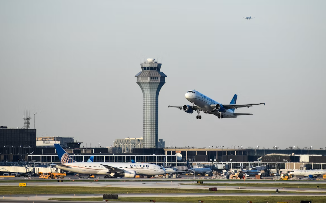 A large white jetliner taking off from an airport runway