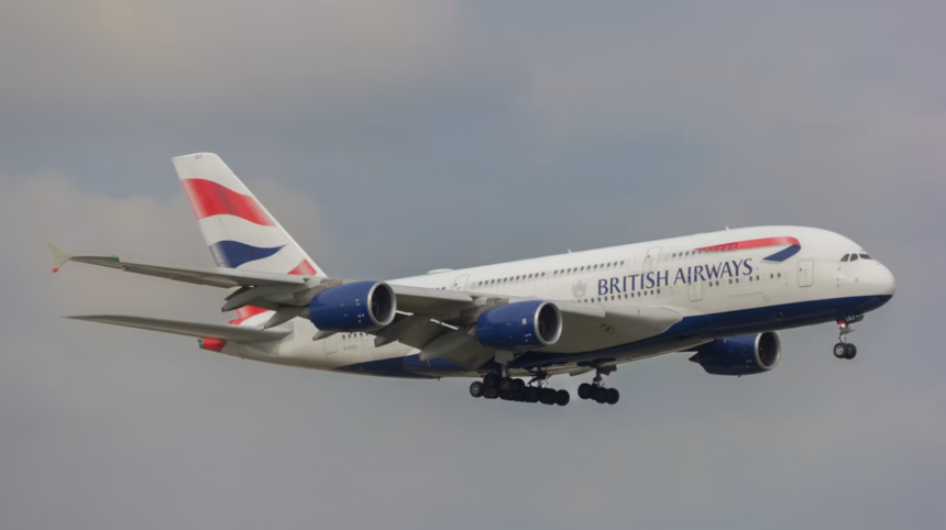 A large white jetliner flying through a cloudy sky