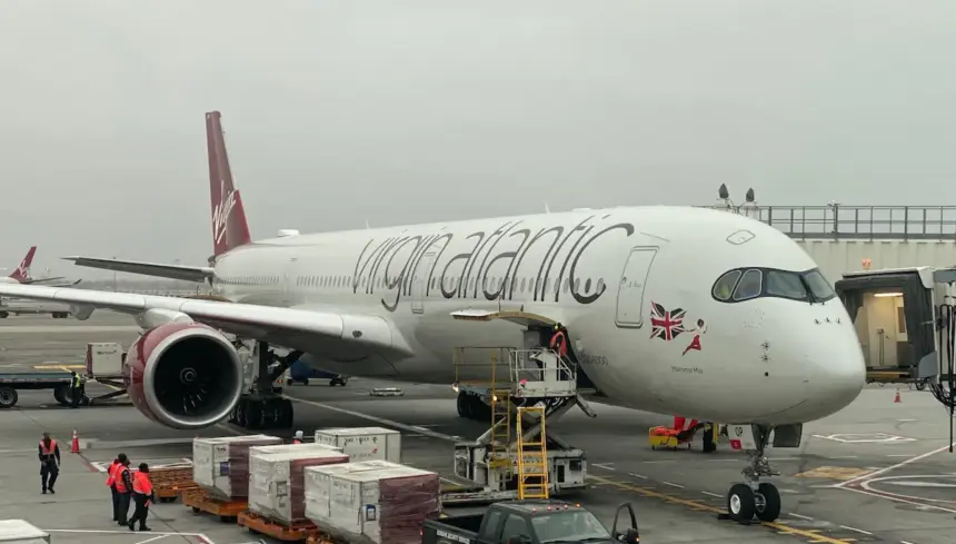 Virgin Atlantic Airbus A350-1000 on runway, being refulled, with palletts and workers surrounding