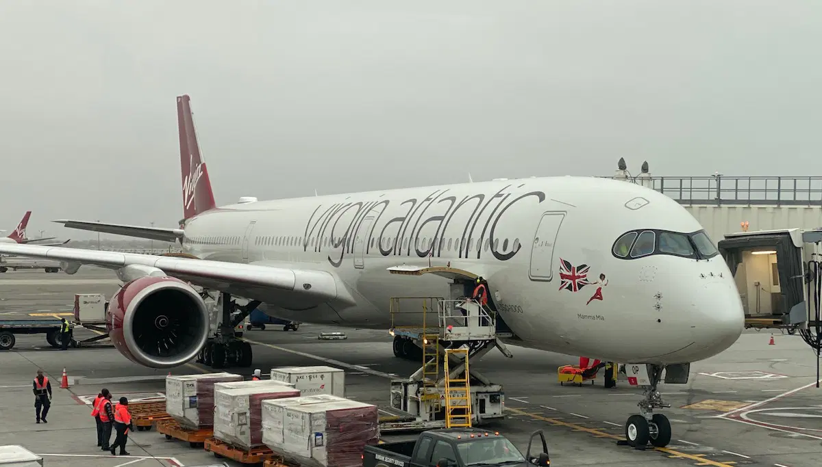 Virgin Atlantic Airbus A350-1000 on runway, being refulled, with palletts and workers surrounding