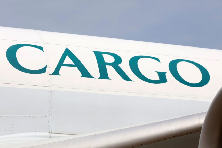 The fuselage of a Cathay aircraft with "Cargo" written in green on a white plane.