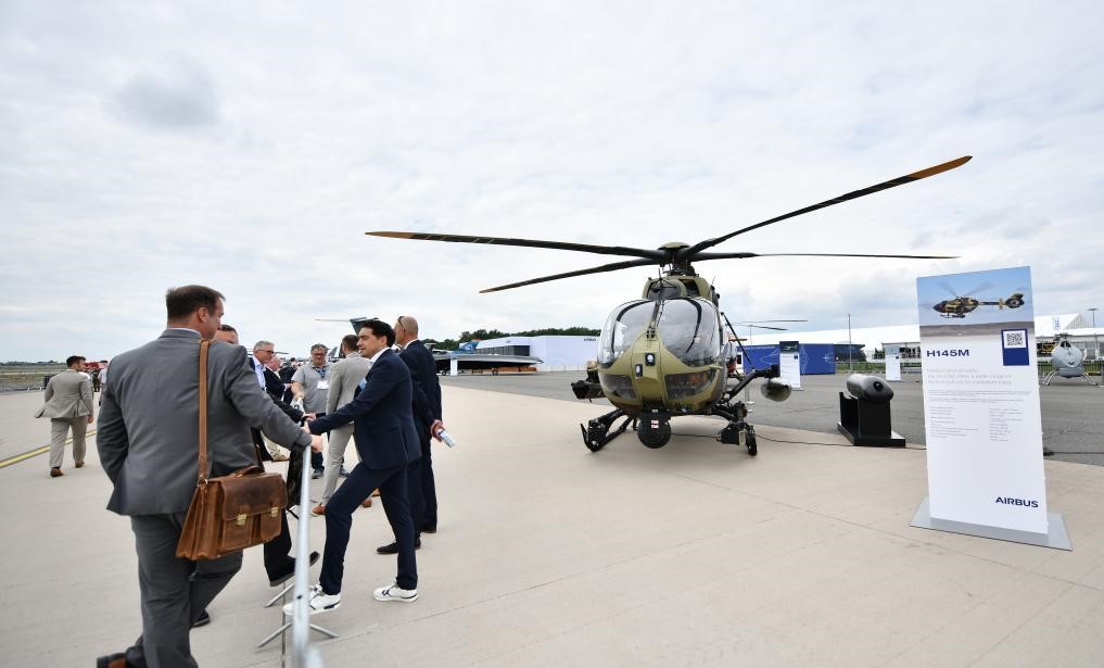 ILA Berlin Air Show 2024, attendees standing near helicopter, in a queue.