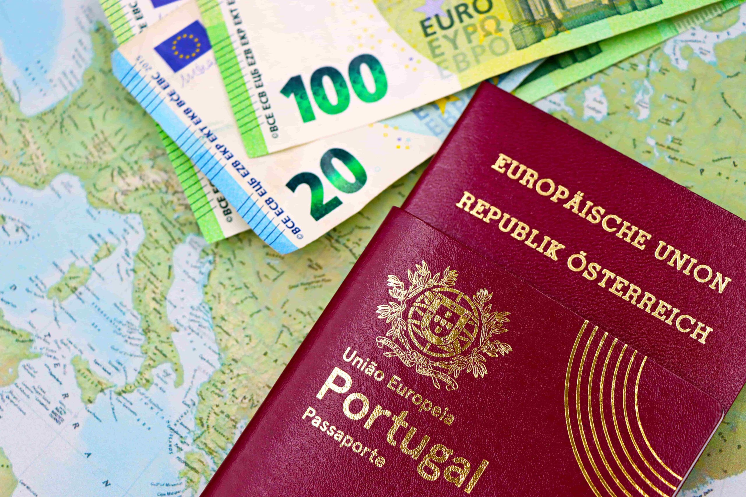 Portugal and Austria passports displayed with Euro currency notes on European map background