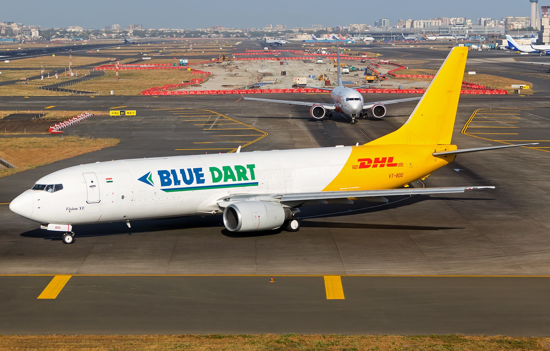 Blue Dart Aviation Boeing 737-800BCF freighter VT-BDD in Blue Dart and DHL livery taxiing at Mumbai airport