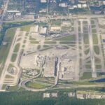 Aerial view of Fort Lauderdale-Hollywood International Airport. The runways are visible, as well as the terminal with the aircraft parked at the gates.
