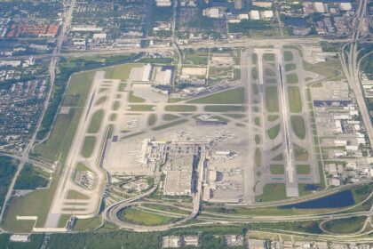 Aerial view of Fort Lauderdale-Hollywood International Airport. The runways are visible, as well as the terminal with the aircraft parked at the gates.