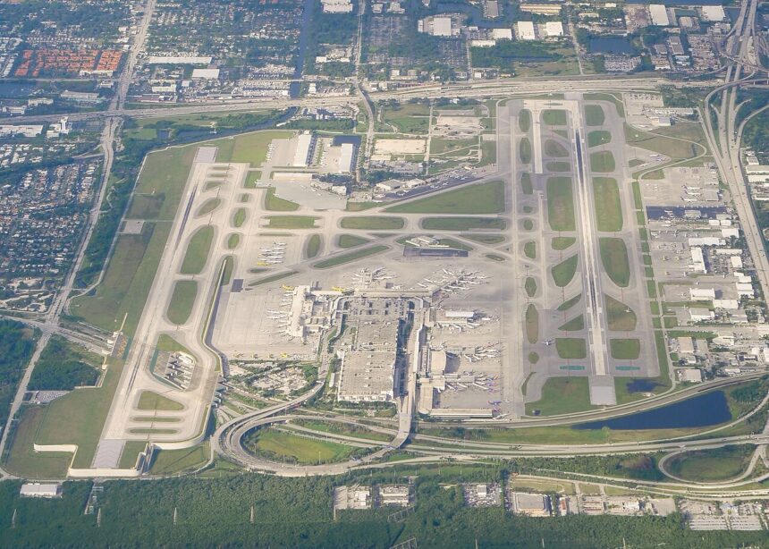 Aerial view of Fort Lauderdale-Hollywood International Airport. The runways are visible, as well as the terminal with the aircraft parked at the gates.