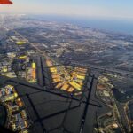 View of Amsterdam Airport Schipol from an airport. The runways are visible and one can see the many lights of the terminals and its surrounding.