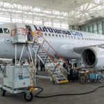 Lufthansa City airlines Airbus A319 in the hanger being worked on with stairs attached to the door