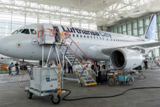 Lufthansa City airlines Airbus A319 in the hanger being worked on with stairs attached to the door