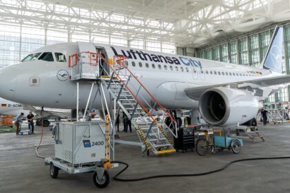 Lufthansa City airlines Airbus A319 in the hanger being worked on with stairs attached to the door