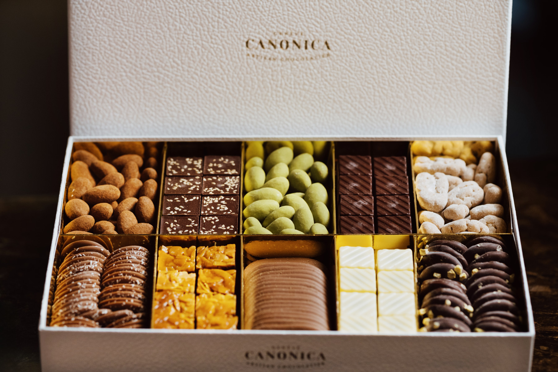 A Canonica box of chocolates, one of Emirates chocolate partners. Featuring various nuts and crackers as well as cubes of white, milk and dark chocolate.