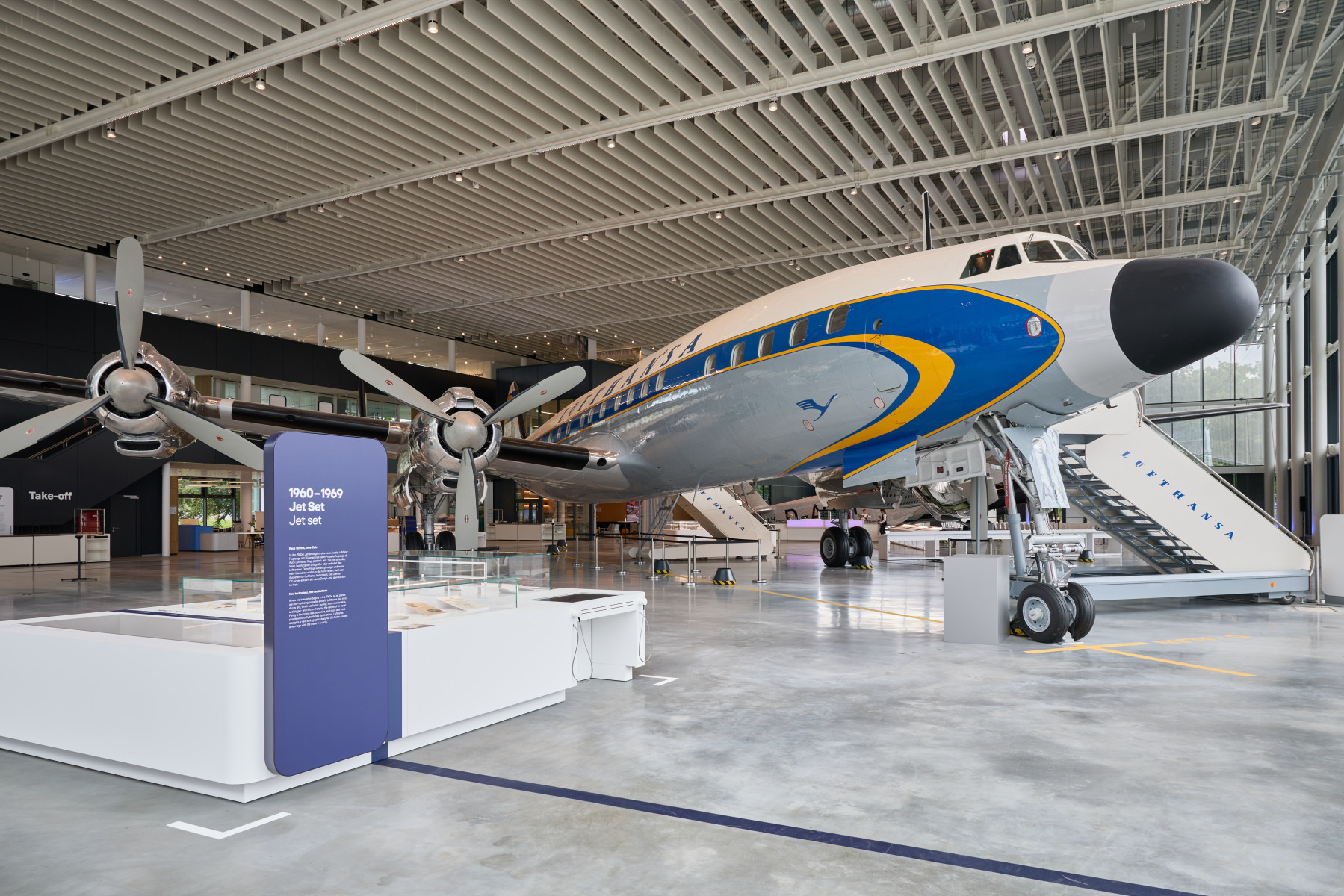 The Lockheed Super Star exhibited with stairs leading into the aircraft and information boards for visitors