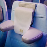 The U-Dream headrest with emirates branding positioned on an economy class chair