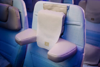 The U-Dream headrest with emirates branding positioned on an economy class chair