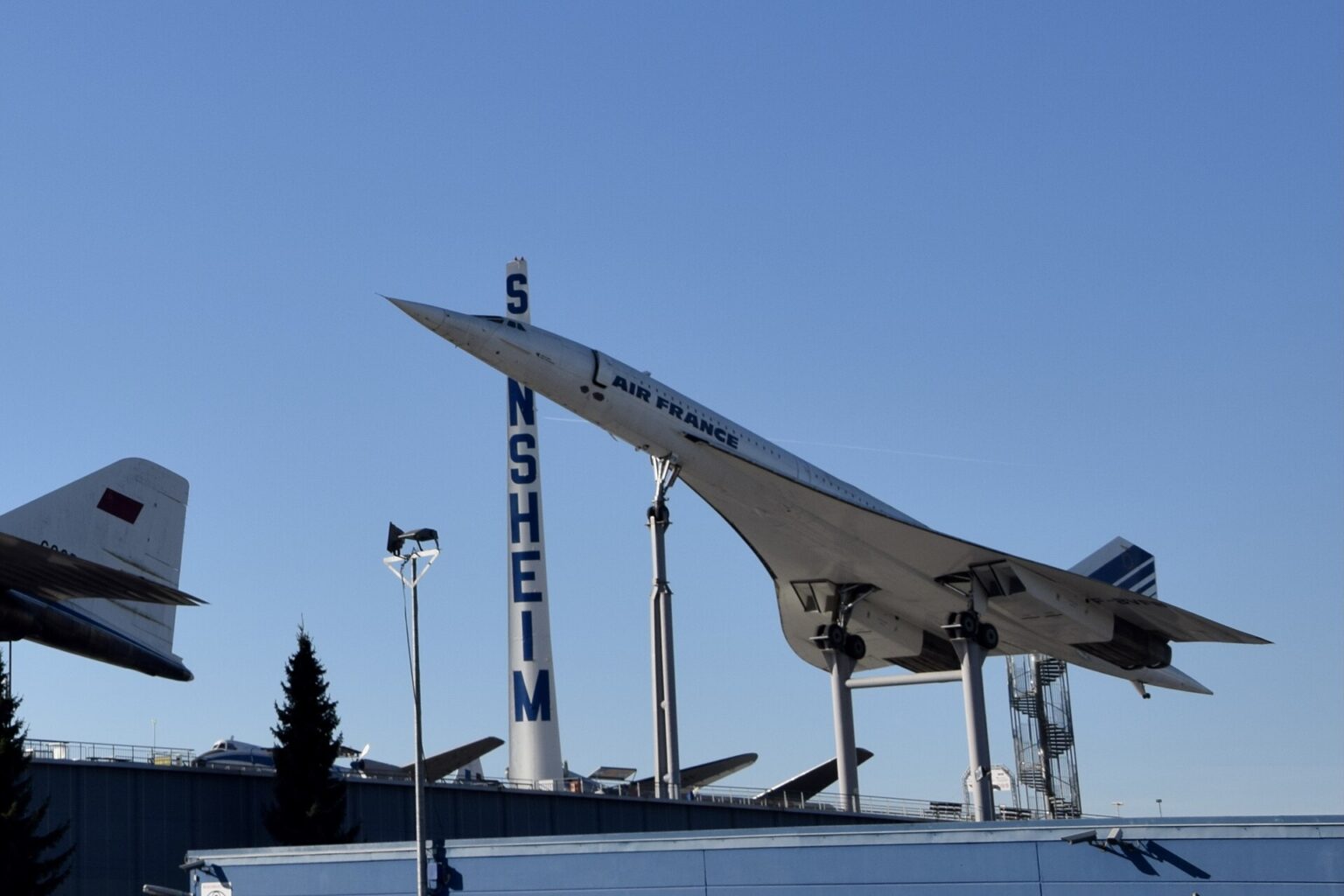 An Air France Concorde aircraft at Technik Museum Sinsheim, Baden-Württemberg, Germany. The long and bizarrely pointed aircraft is elevated on columns for display.