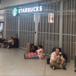 Travellers sat on the floor outside a closed Starbucks at Gatwick Airport.