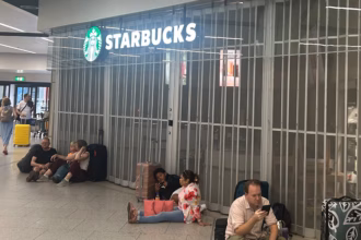 Travellers sat on the floor outside a closed Starbucks at Gatwick Airport.