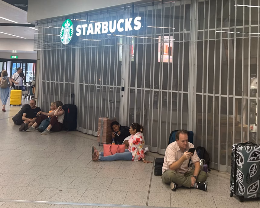 Travellers sat on the floor outside a closed Starbucks at Gatwick Airport.