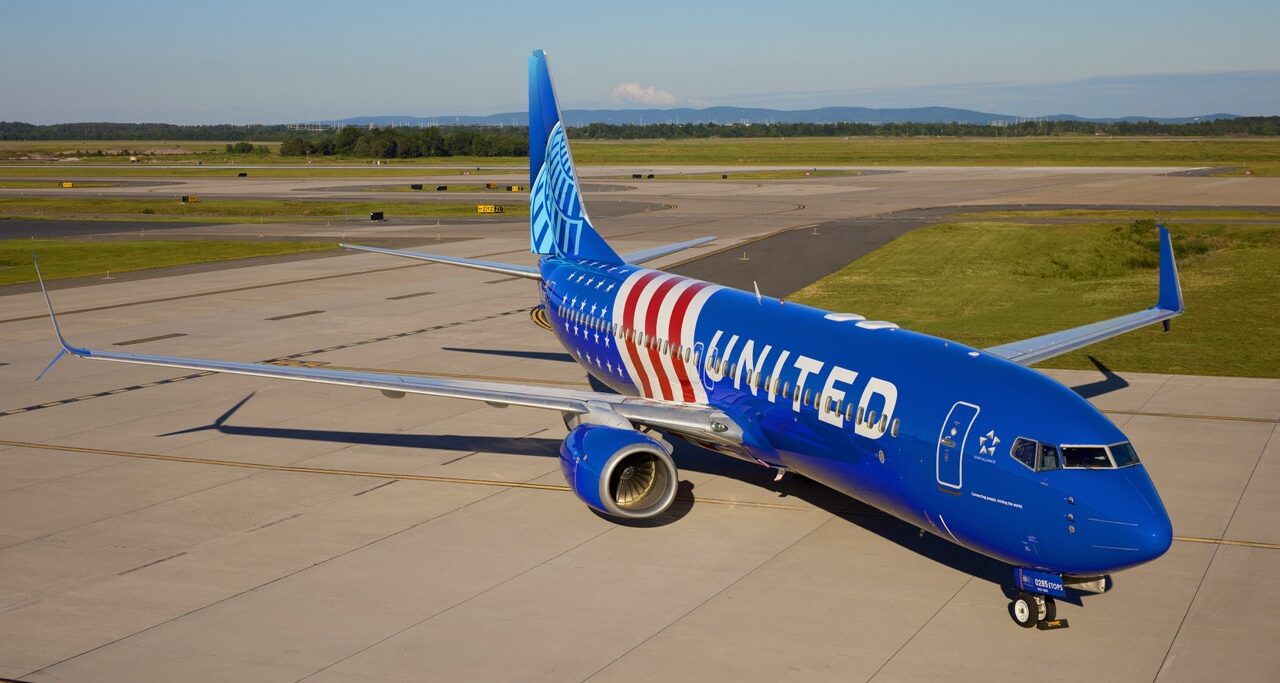 United Airlines new livery. Blue fuselage, with white and red stripes across the back end.