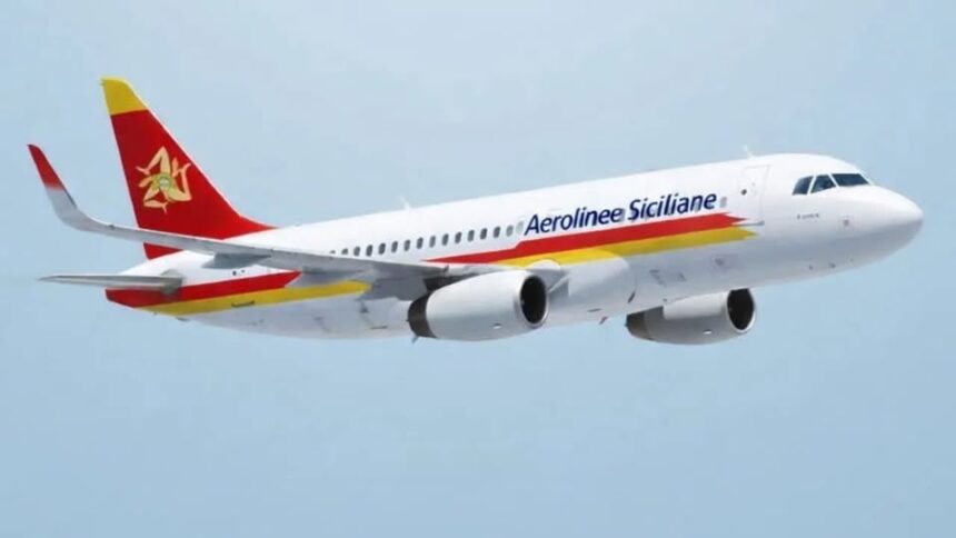 An Aerolinee Siciliane aircraft flying in the blue sky. White, red and yellow livery.