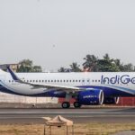 An IndiGo Airbus A320neo taxis along the runway at Mumbai Airport in the airline's distinctive blue-and-white livery. The fuel-efficient narrowbody aircraft, powered by next-generation engines, is preparing for departure on one of the carrier's domestic or international routes