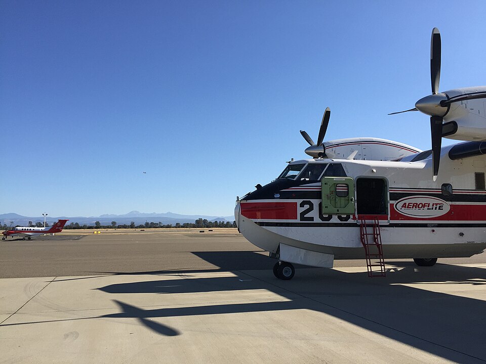 Image shows a CL-415 aircraft grounded at Redding, California during the day